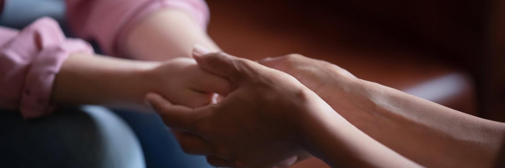 Holding_hands_dark_background