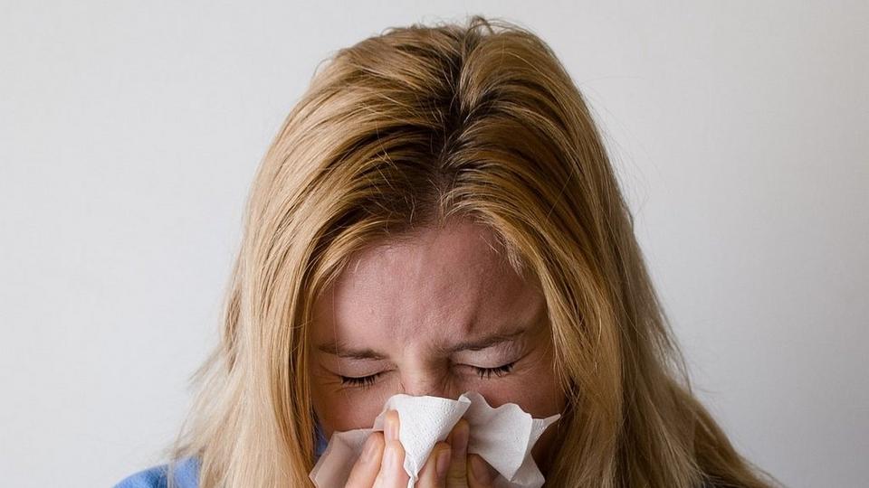 woman-blowing-nose-tissue